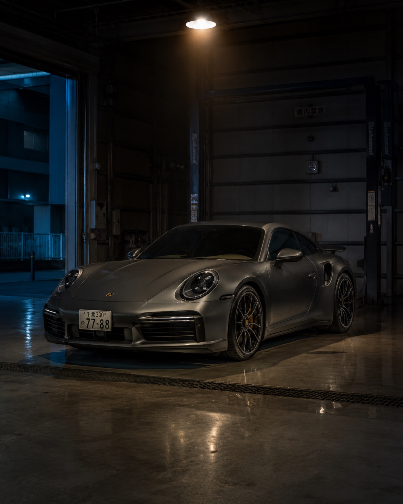 Porsche 911 Turbo in a Japanese inspection bay — premium export operation
